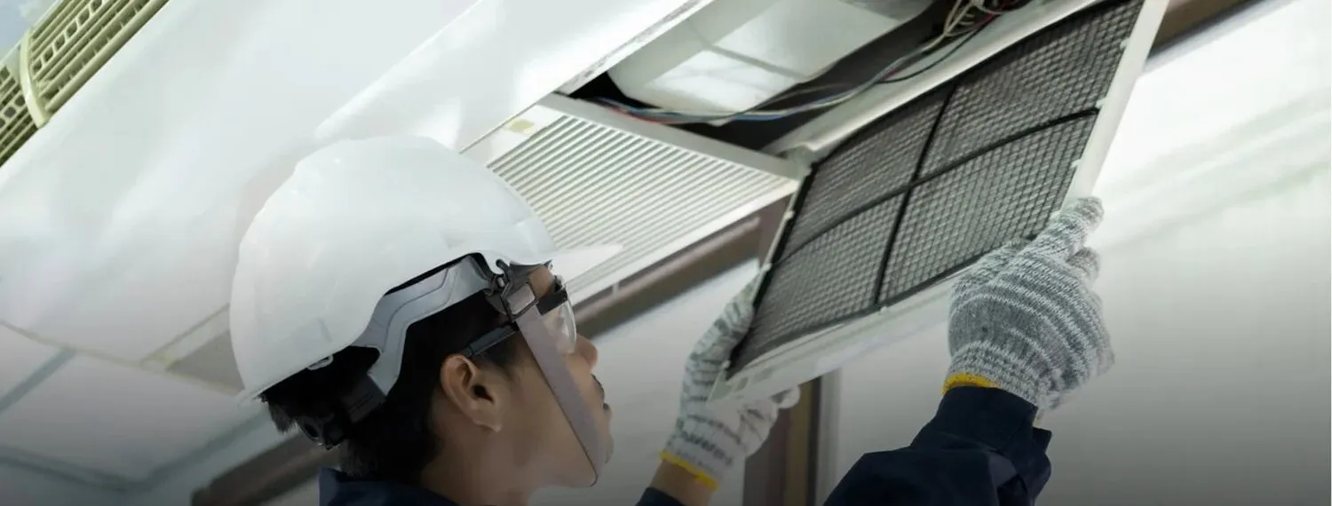 Technician replacing an air conditioning filter