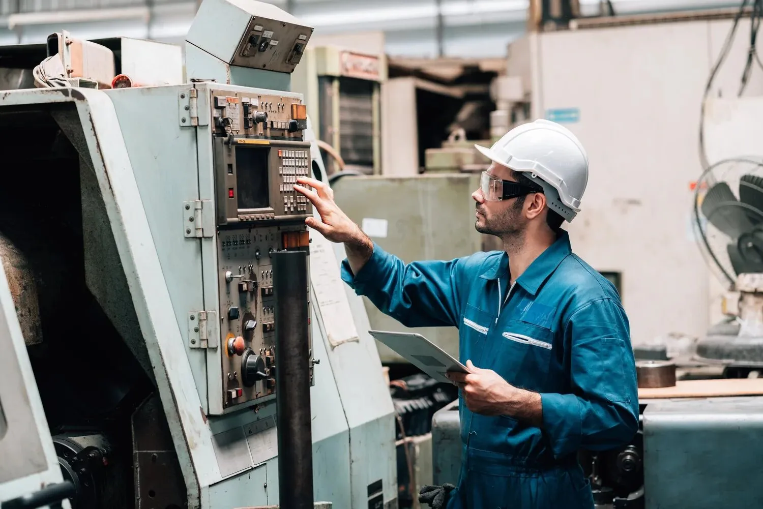 Technician checking equipment with a tablet