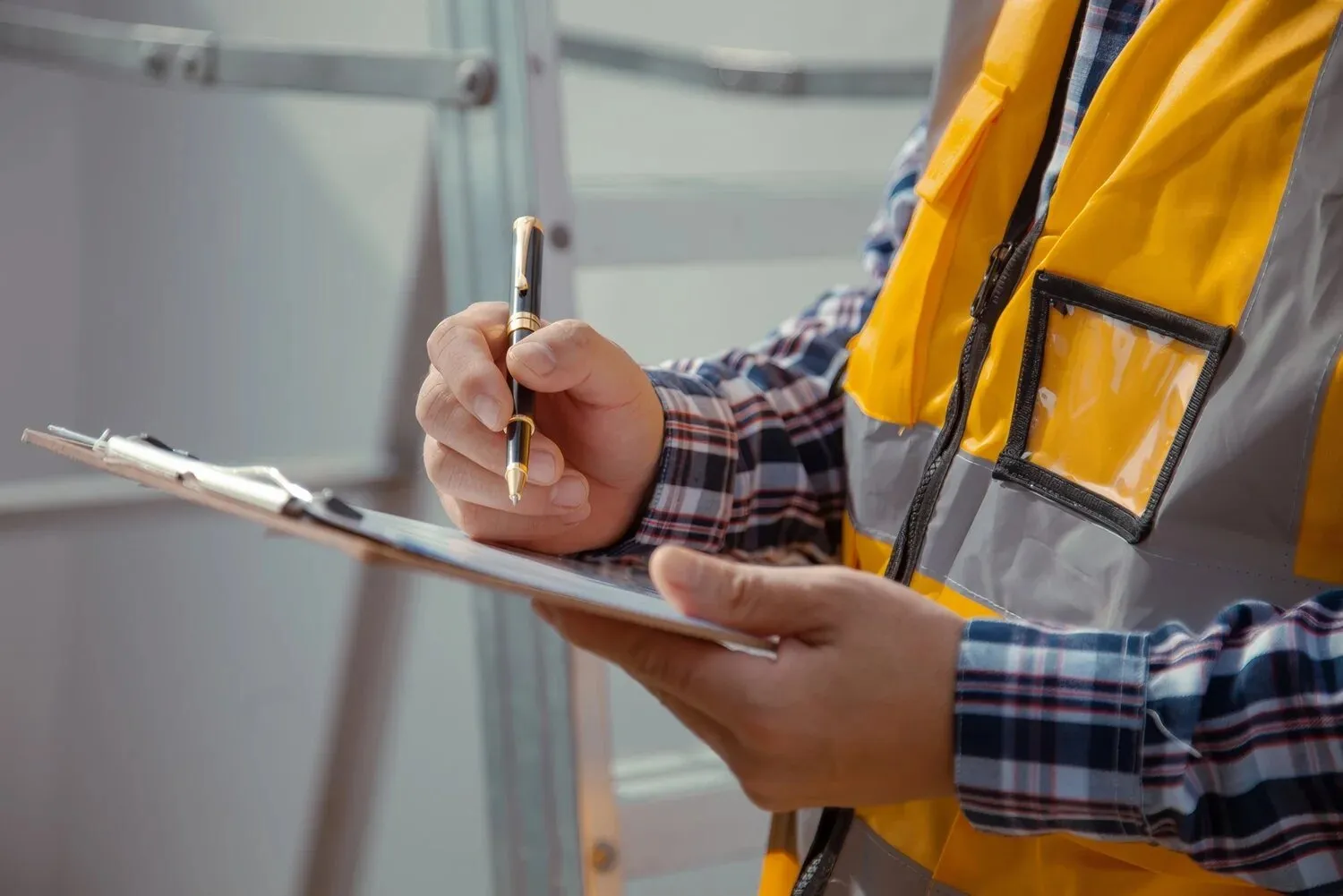 Inspector completing a checklist on a clipboard