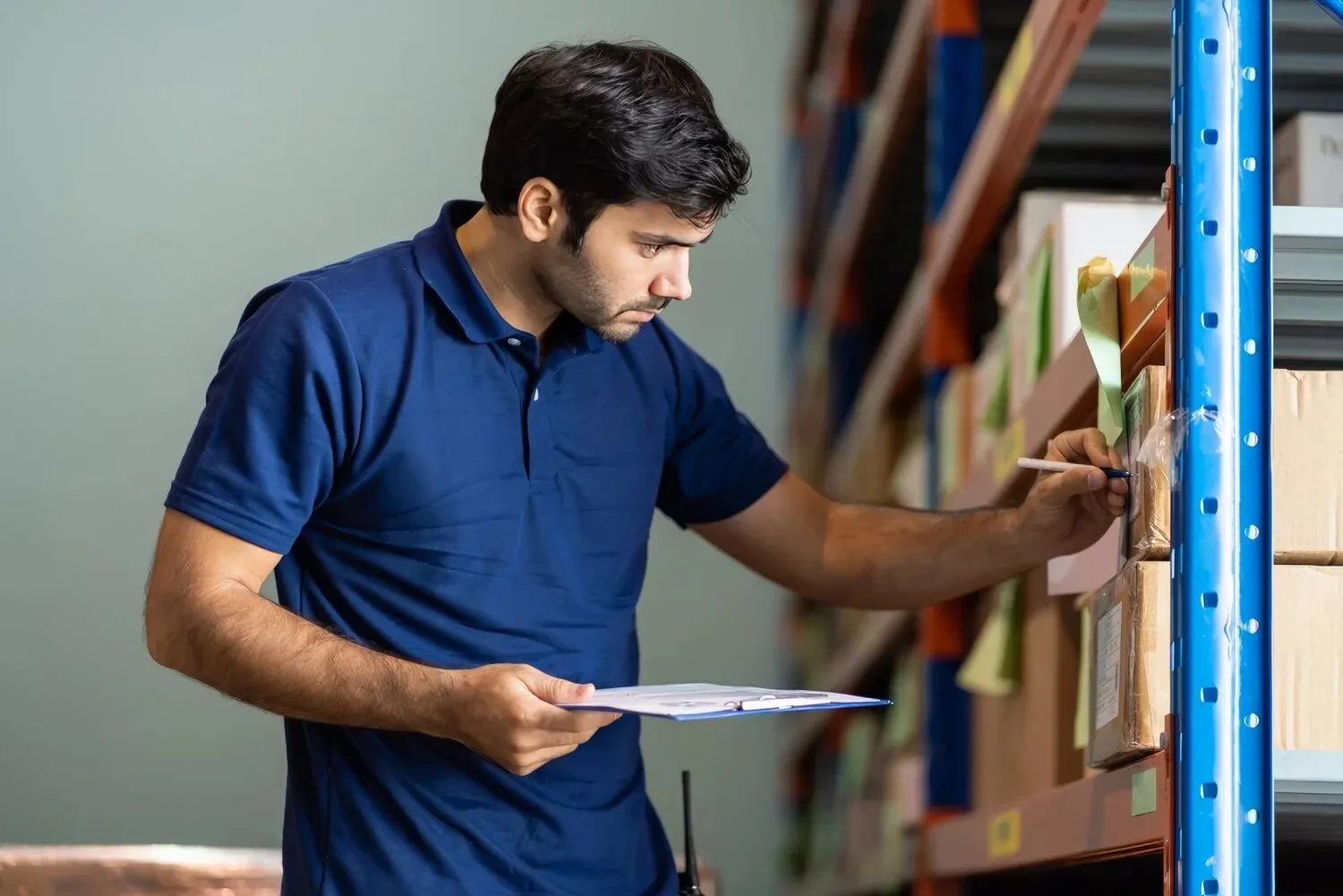 Supply coordinator checking stock on shelves